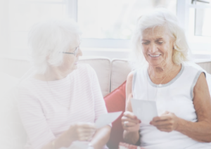 Compassionate Senior Home Care in Scottsdale AZ Senior caregiver and older woman smiling together at home in Scottsdale AZ